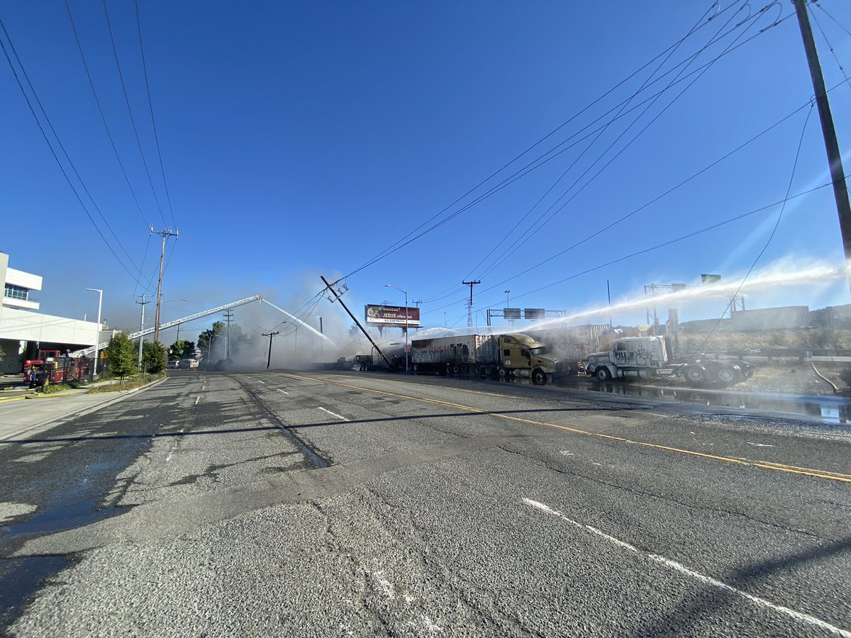 Firefighters are on scene at 1st Ave. S. and East Marginal Way S. for a brushfire that extended to an RV, several semi-trucks and at least two utility poles. Crews have water on the fire and no injuries were reported