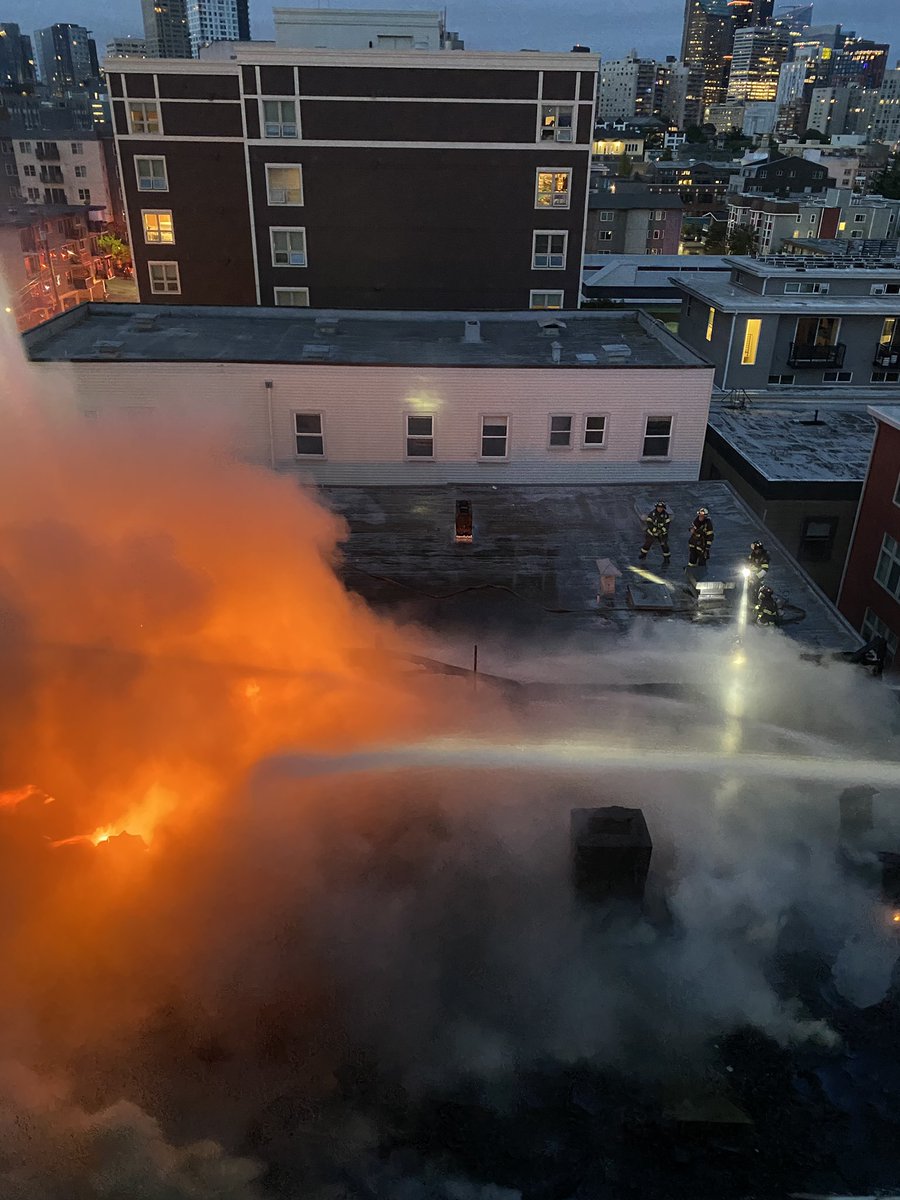 Flames are through the roof of the vacant building