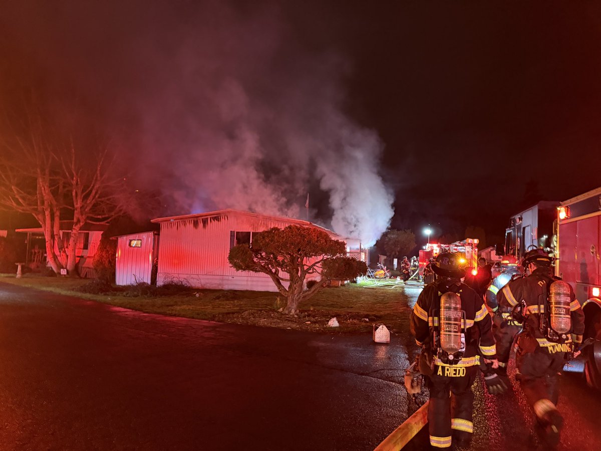 Puget Sound Fire is on location of a mobile home fire in the 1500 block of Maple Lane, in Kent. Firefighters arrived and found a double-wide modular home with flames coming from the inside and from the roof