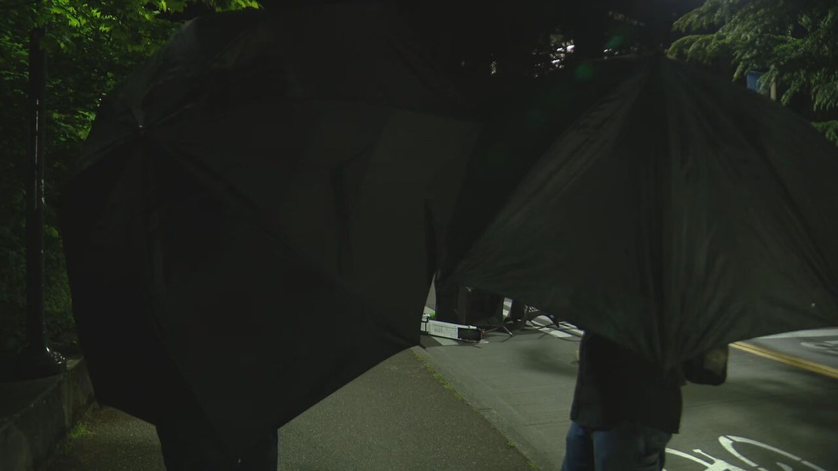 The group is now blocking Stevens Way. Members of the group are intermittently blocking press cameras with umbrellas. No indications the people occupying the building have left