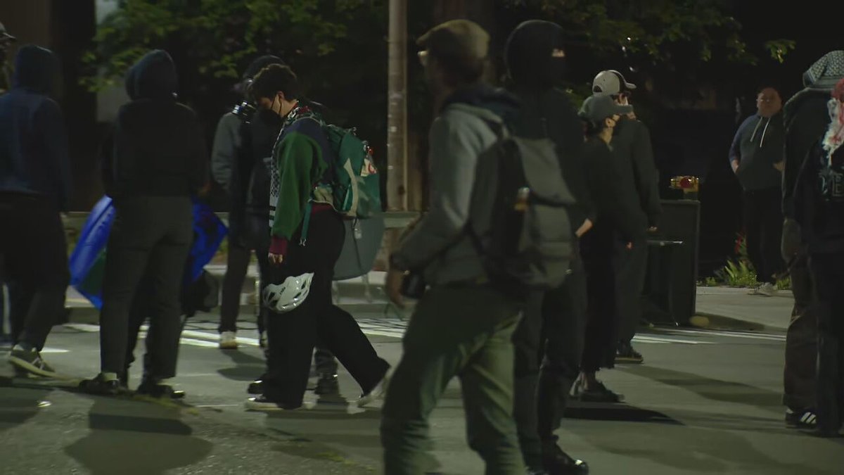The group is now blocking Stevens Way. Members of the group are intermittently blocking press cameras with umbrellas. No indications the people occupying the building have left 