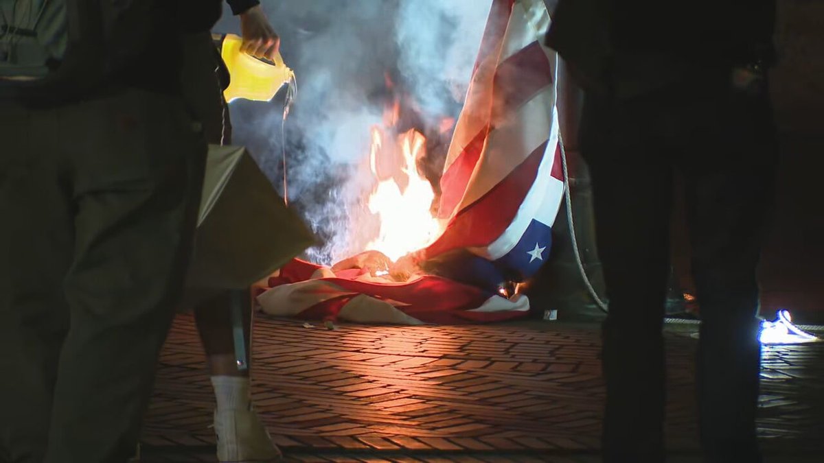 A second American flag was taken down and burned on the east side of the federal building. (Intersection of 1st Ave and Madison)