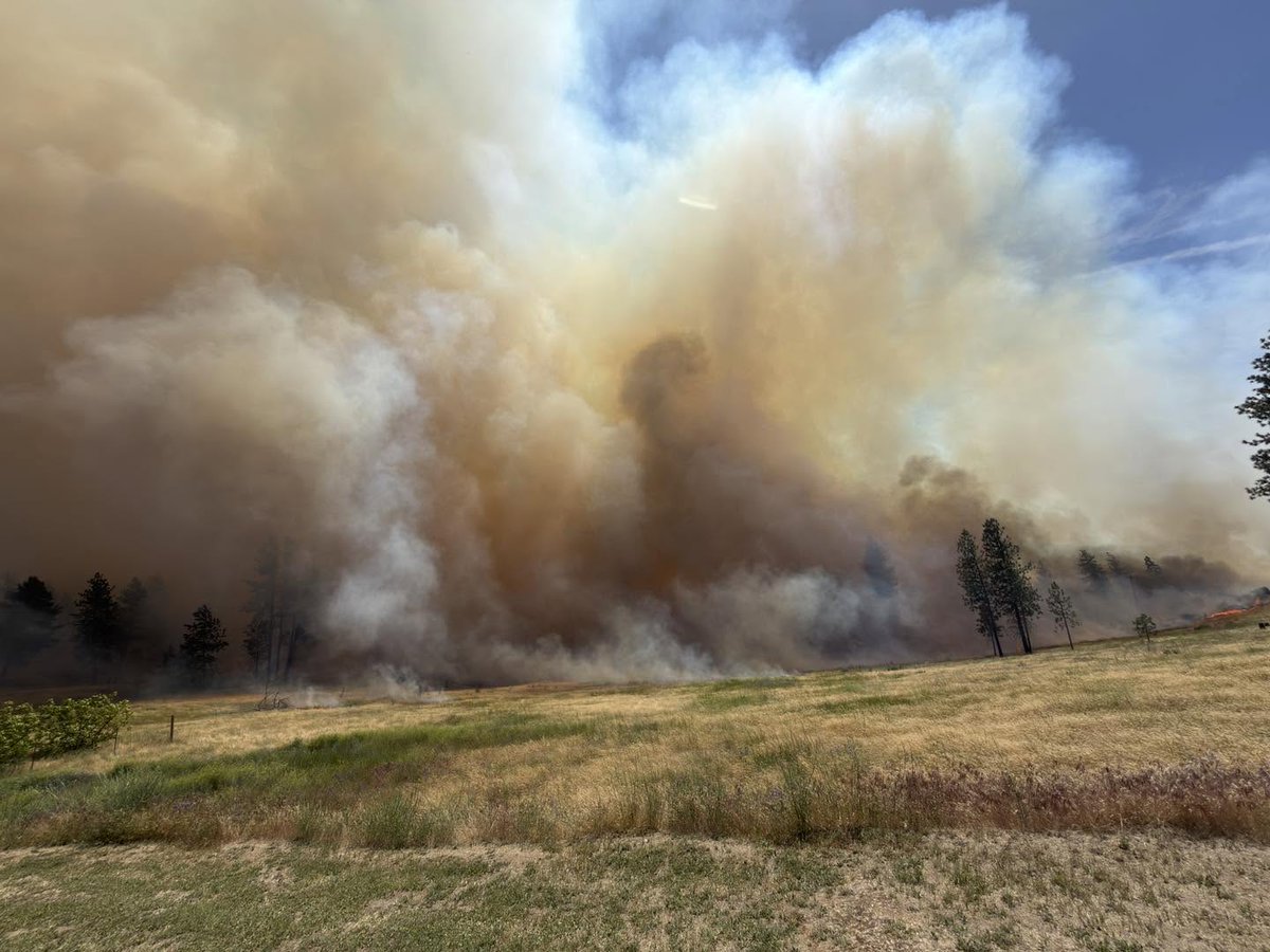 A fast-growing wildfire in Spokane has destroyed at least 15 homes, and 12,000 people are under evacuation orders in Spokane Valley, officials say: